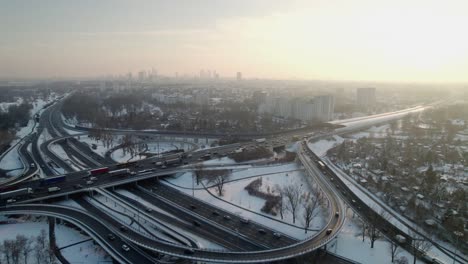 Orbit-establishment-aerial-footage-at-sunset-of-Warsaw-city-in-Poland-during-the-rush-hour,-large-amount-of-traffic-in-the-road