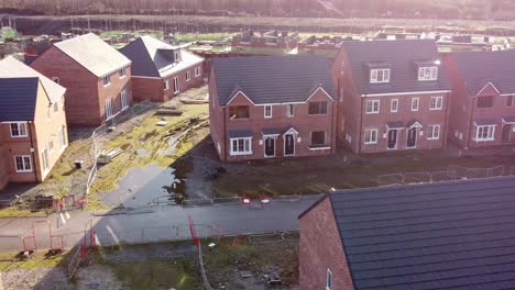 Unfinished-waterfront-townhouse-property-development-construction-site-aerial-view-dolly-right