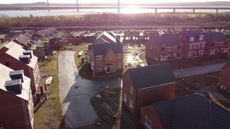 Unfinished-waterfront-sunlit-townhouse-property-development-construction-site-aerial-view