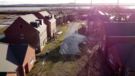 Abandoned-waterfront-townhouse-development-construction-site-aerial-view-dolly-right