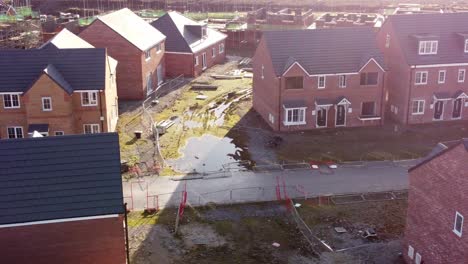 Abandoned-townhouse-property-development-construction-site-aerial-view-dolly-left