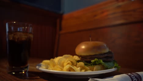 hamburger-with-potato-chips-at-restaurant-table-meal