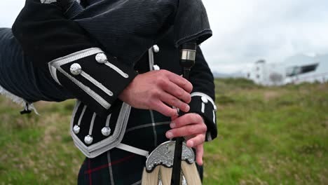Close-up-shot-of-a-bagpiper-playing-a-song-in-his-traditional-Scottish-kilt