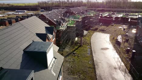 Unfinished-waterfront-townhouse-framework-on-development-construction-site-aerial-view