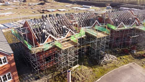 Townhouse-property-development-framework-and-scaffolding-abandoned-on-construction-site-aerial-orbiting-view