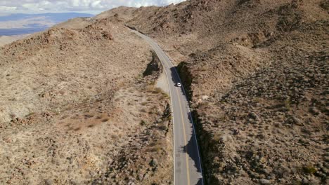 Aerial-View-of-Highway-74-Near-Palm-Desert,-California-with-Cars-Passing-Below-at-Midday
