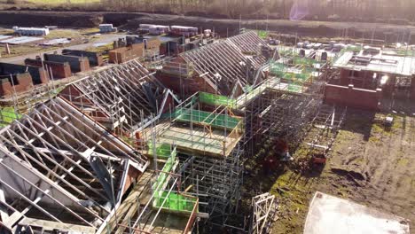 Unfinished-timber-scaffolding-framework-on-townhouse-property-development-construction-site-aerial-view