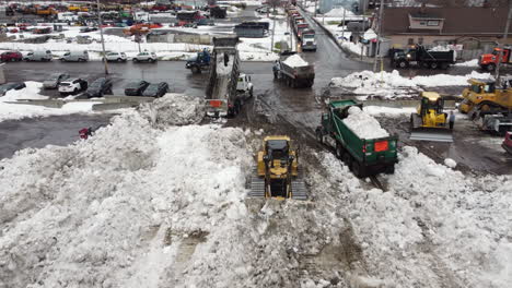 snowplow-and-trucks-pile-up-and-accumulate-snow-after-buffalo-historic-severe-blizzard-at-the-end-of-2022