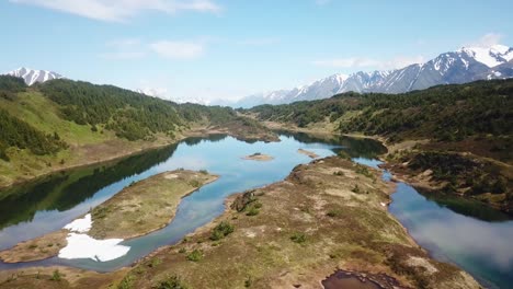Rising-drone-shot-of-a-secluded-mountaintop-lake-in-Alaska