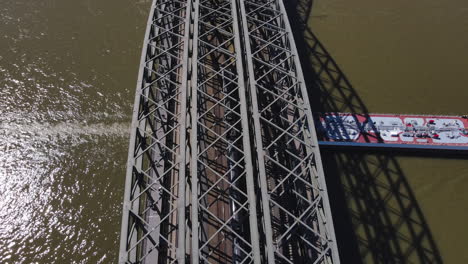 Aerial-top-view-Hohenzollern-Bridge-while-Cargo-boat-crosses-it-Cologne-Germany