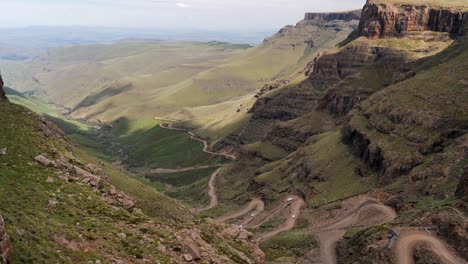 AWD-traffic-on-wild-dirt-switchbacks-of-Sani-Pass-in-Lesotho,-Africa