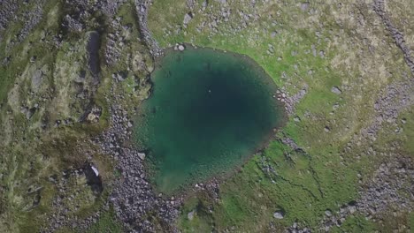 Lowering-drone-shot-of-an-isolated-lake-in-backcountry-Alaska