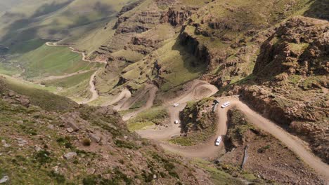 Tour-vehicles-slowly-descend-rough-and-rugged-Sani-Pass-in-S-Africa