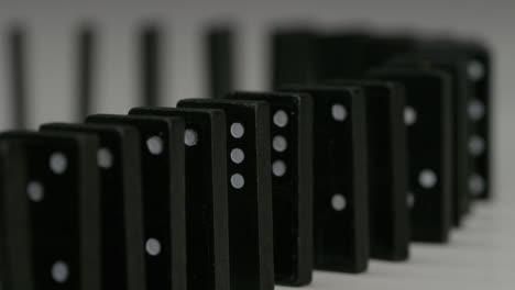 curved-row-of-black-dominoes-with-white-spots