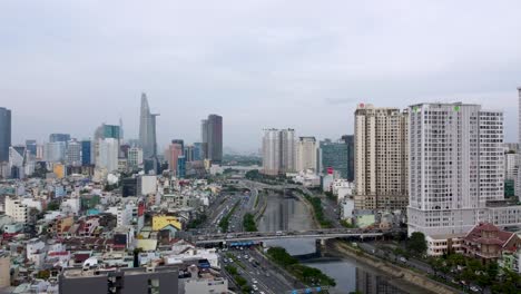 Aerial-view-of-Saigon-city-panorama,-traffic-crossing-bridge-over-Sai-Gon-river,-Vietnam