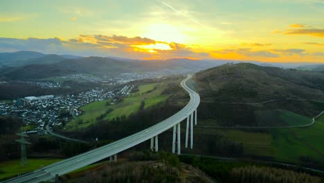 North-Rhine-Westphalia's-Tallest-Autobahn-Bridge,-Talbrücke-Nuttlar,-during-Golden-Hour-Sunset:-A-High-Speed-Transportation-Scene