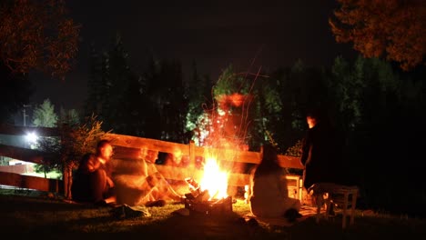 Group-Of-Young-People-Having-Good-Time-Together-Around-The-Campfire-On-A-Hillside