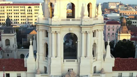 Aerial-scaling-up-Pasadena-City-Hall-with-city-in-background,-cinematic-establishing-view-during-the-day
