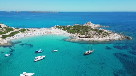 Boats-at-Punta-Molentis-Beach-Peninsula-in-Villasimius,-Sardinia---Aerial-4k