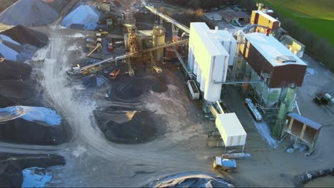 An-aerial-view-of-a-rock-truck-maneuvering-around-a-limestone-quarry-and-lime-plant-showing-the-heavy-machinery-behind-lime-production-in-germany