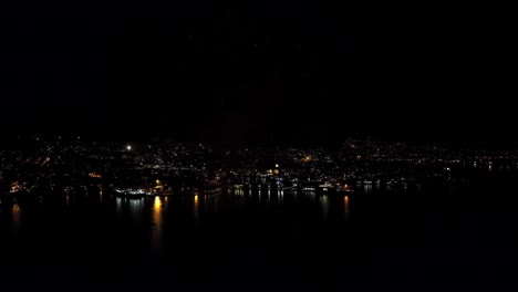 Wide-angle-aerial-parallax-of-New-Years-fireworks-in,-Bergen-Norway