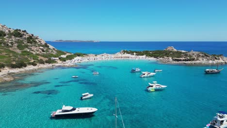 Boats-and-Yachts-at-Punta-Molentis-Beach,-Villasimius,-Sardinia---Aerial-4k