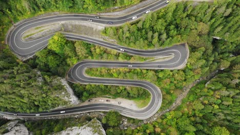 Overhead-View-Of-Vehicles-Driving-On-Serpentine-Highway-In-Cheile-Bicazului,-North-eastern-Romania