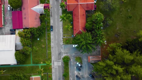 Cinematic-Drone-Footage-of-Palm-Oil-Mill-Effluent-residential-consists-of-buildings,-homes,-main-road-and-infrastructure-surrounded-by-palm-oil-trees-deforestation-located-in-Indonesia-in-full-HD
