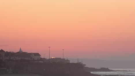 Panoramic-sunrise-view-over-Parede-from-a-viewpoint-in-Cascais-morning-timelapse