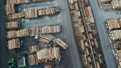 Harvesting-and-Processing-Timber:-Aerial-View-of-Logging-Trucks-Unloading-and-Logs-at-a-Sawmill-in-Germany