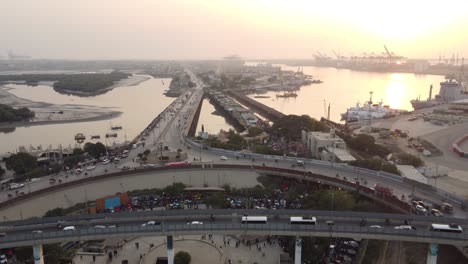 Aerial-View-Of-Native-Jetty-Road-And-Jinnah-Flyover-With-Karachi-Port-Terminal-In-Background-During-Sunset