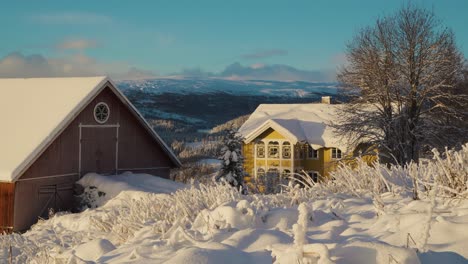 Static-shot-of-colorful-houses-on-mountaintop-during-lighting-snowy-day-in-winter---Norway,-Innlandet,-Valdress,-Beitostolen,-Beito