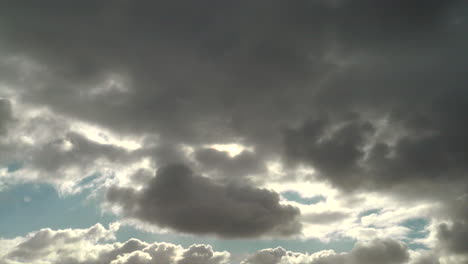 Grey-and-white-clouds-moving-across-the-sky-and-in-front-of-the-sun,-Australia