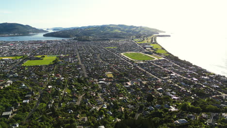Aerial-panorama-of-downtown-Dunedin-port-city,-South-Island,-New-Zealand