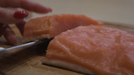 Slicing-salmon-fillet-with-a-kitchen-knife---Closeup