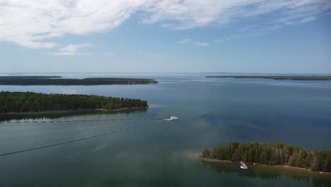 Aerial-Shot-of-Lake-Archipelago-with-Lone-Yacht-Boat---Les-Cheneaux-Islands,-Michigan