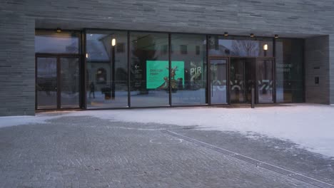 View-Of-Entrance-To-The-National-Museum-of-Art,-Architecture,-and-Design-In-Oslo,-Norway-With-Snow-Falling