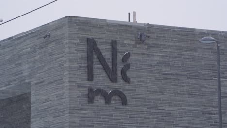 The-National-Museum-of-Art,-Architecture,-and-Design-Lettering-On-Side-Of-Building-Is-Oslo,-Norway-During-Heavy-Snow-Fall