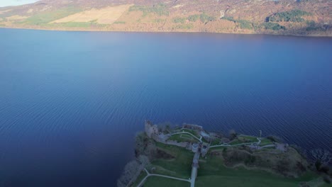 Drone-Flying-around-Urquhart-castle,-Loch-Ness-lake-in-Scotland-aerial