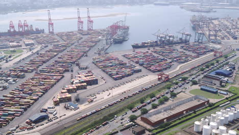 Wide-aerial-pan-of-the-shipping-container-yard-and-cargo-ships-in-Durban-Harbour