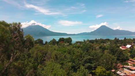 Aerial-Fly-Away-from-Lake-and-Volcanoes---Summer---Lake-Atitlan,-Panajachel,-Guatemala