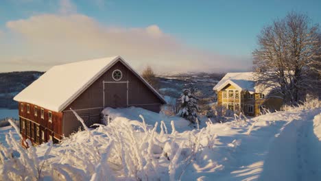 Beautful-snow-landscape-with-snowy-roof-of-apartment-houses-in-Norway-during-winter-in-the-evening
