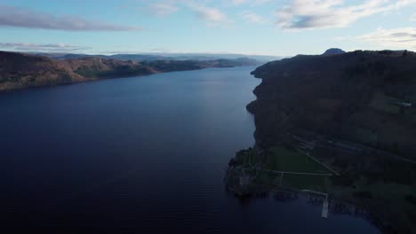 Stunning-establisher-aerial-view-of-Urquhart-Castle-by-Lochness-lake,-pan
