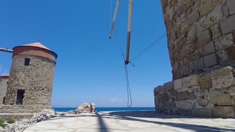 Low-Angle-Shot-Beside-Windmills-At-Mandraki-With-Blue-Sky-In-Rhodes
