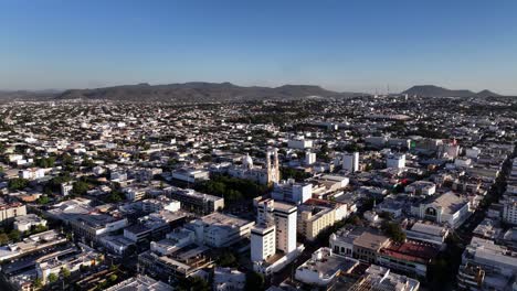 Aerial-view-towards-the-Cathedral-in-Culiacan-Rosales,-golden-hour-in-Sinaloa,-Mexico