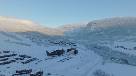 Myrkdalen-valley-leading-to-mountain-Vikafjell---Winter-aerial-above-road-rv13-with-Myrkdalen-hotel-and-skiing-resort-to-the-left