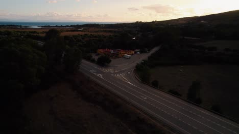 Lowering-aerial-view-of-a-highway's-intersection-while-the-sun-is-setting-in-Spain
