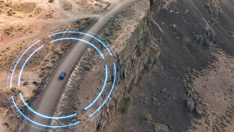 Drone-shot-of-a-self-driving-blue-SUV-sensing-its-way-through-a-unique-cliffside-environment