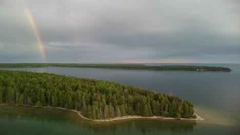 Aerial-Shot-of-Double-Rainbow-on-Lake-Huron-in-Les-Cheneaux-Islands,-Michigan