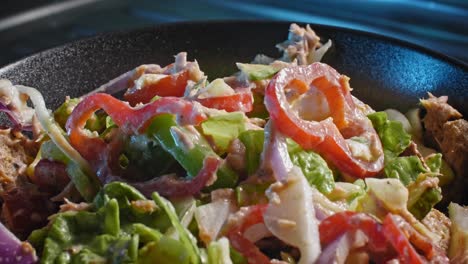Static-shot-of-a-finished-tuna-salad-salad-served-in-a-black-bowl